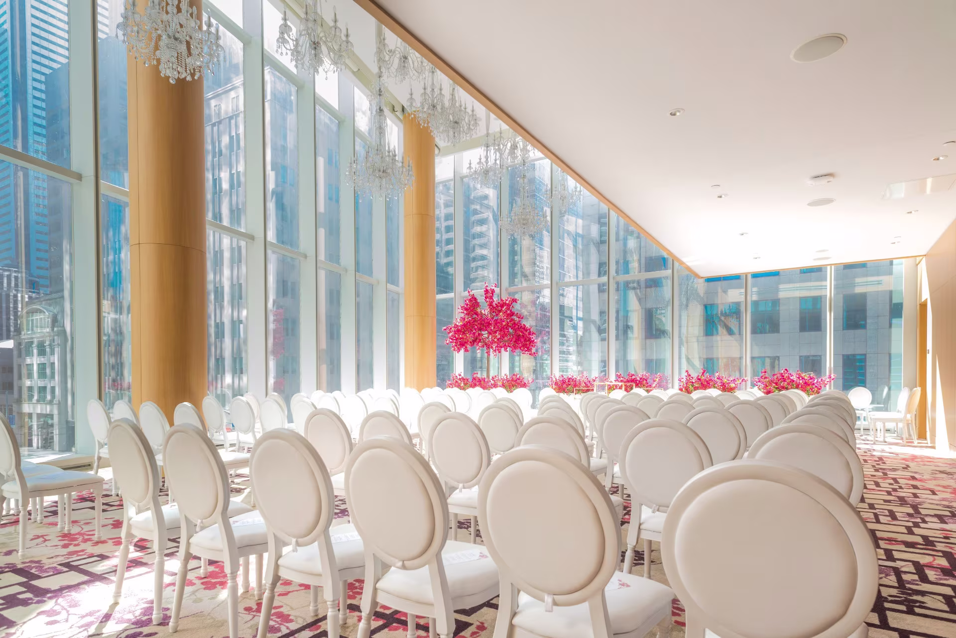 Bespoke Event Rentals Gallery featuring elegant indoor wedding ceremony seating with white chairs and city views